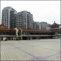 Open plaza in Chongqing surrounded by high-rise buildings, with only the upper portions visible from this elevated level
