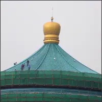 Workers navigating the steep roof of the Great Hall of the People during maintenance