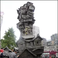 Metal sculpture of stacked, irregular houses in a public space at Hongyadong