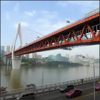 Qiansimen Bridge crossing the river in Chongqing, with the grey-green Grand Theatre in the background, both appearing layered from this angle