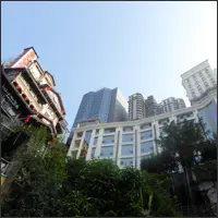 Upward view of Hongyadong’s stacked buildings and balconies against the sky