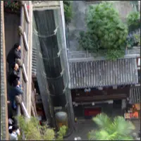 People standing along a railing at Hongyadong looking down at lower levels with restaurants and walkways