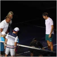 Roger Federer standing at the net after the coin toss, preparing for the start of a match at the Shanghai Masters