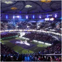 Wide view of the illuminated stadium during a night match at the Shanghai Masters, with a packed crowd surrounding the court
