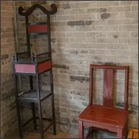 Wooden chairs displayed as part of an optical illusion exhibit.