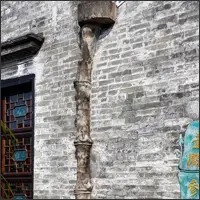 Decorative stone rain gutter on the wall of Yuyin Shanfang Garden.