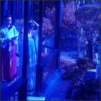 Visitors seen through a blue stained-glass window in Yuyin Shanfang Garden.