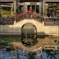 Stone bridge over a pond in Yuyin Shanfang Garden.