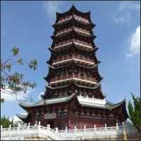 Multi-story red pagoda rising above the trees in Tanhuasi Park, Kunming.