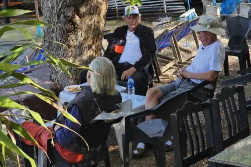 Open-air seating at Bay Camp Cafe under trees in Khao Ta Mong Lai Forest Park, Prachuap Khiri Khan