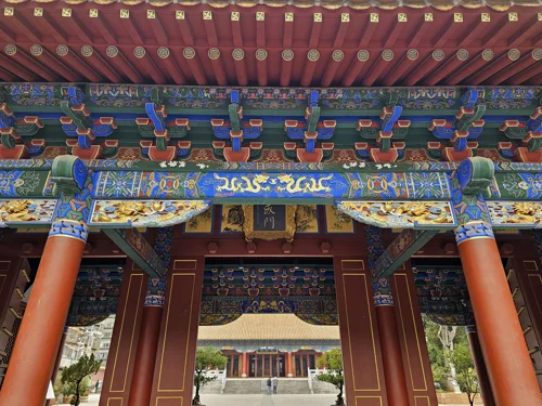 Intricate red and green temple gate and structure inside Wenmiao, richly painted and well maintained