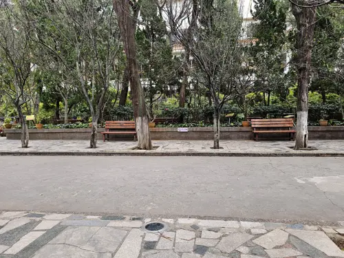 Empty paved path leading toward temple buildings at Wenmiao, noticeably quiet and without visitors.
