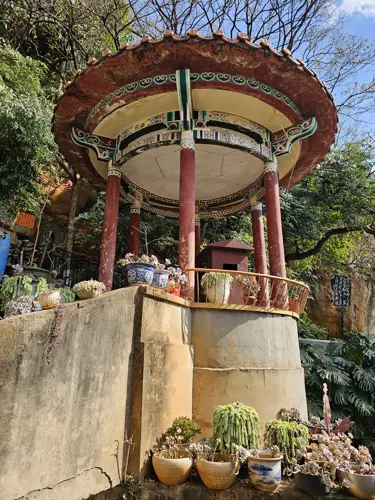 Small pagoda at Yuantong Temple with its former access path lined by decorative planters and no longer open to visitors.